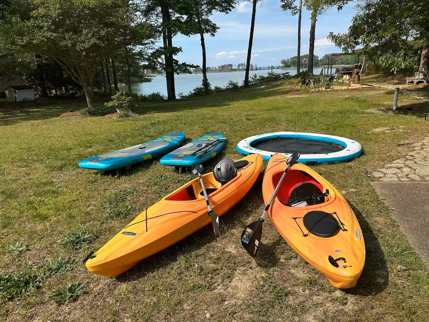 Kayaks and paddle boards in the yard